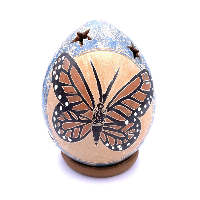 Handcrafted ceramic luminary featuring a beautifully detailed butterfly design with cut-out stars. Perfect for creating a warm, decorative glow in any room or outdoor space.