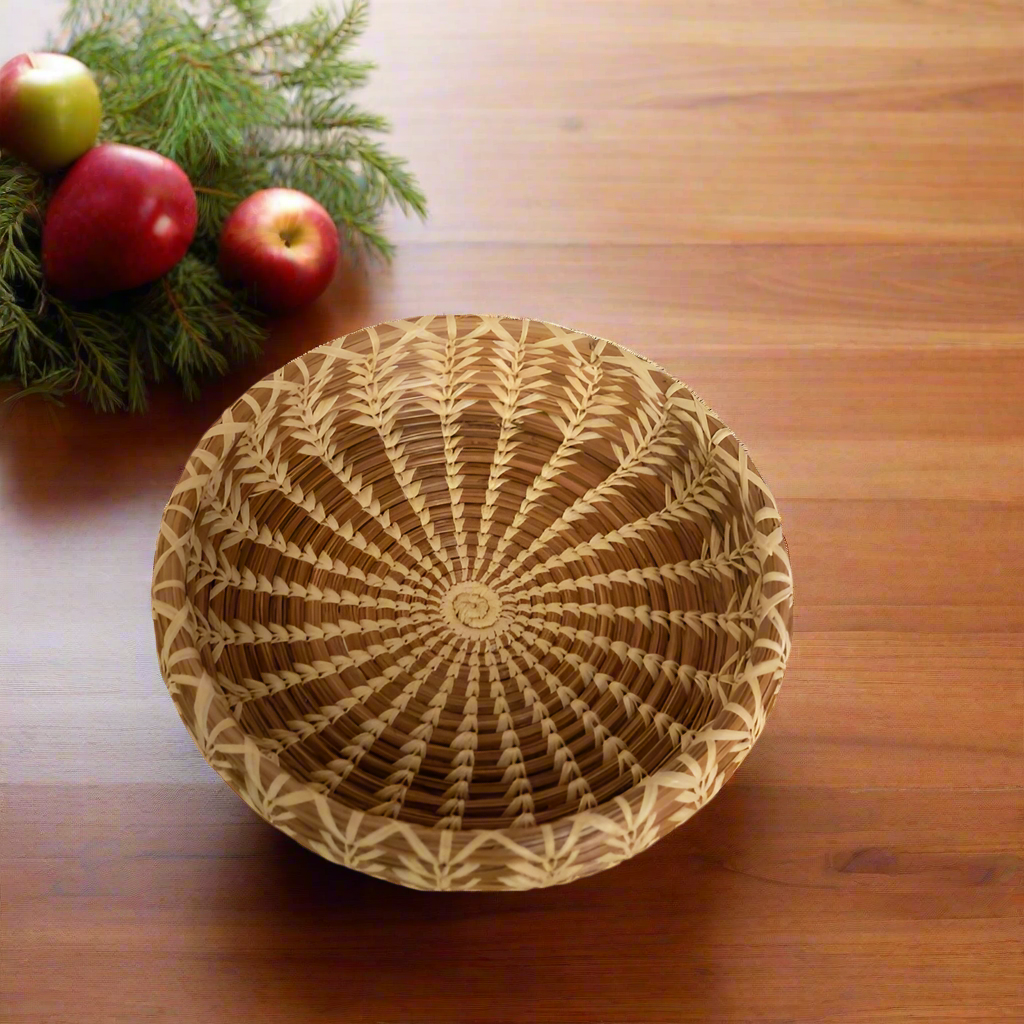 Handwoven pine needle basket filled with fresh red grapes, showcasing its natural, artisanal design. Perfect for serving fruit or adding rustic charm to your kitchen or dining decor.