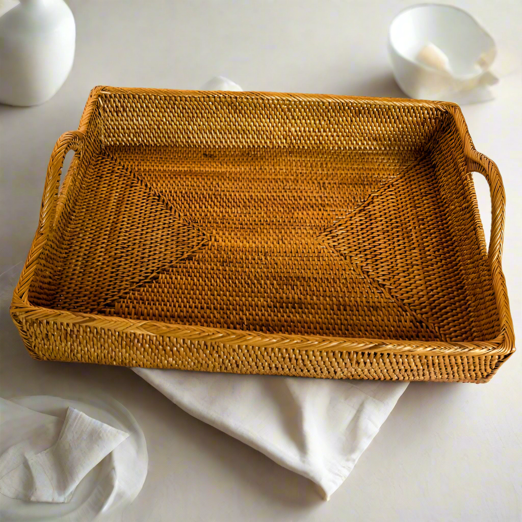 Handwoven rectangular rattan tray with sturdy handles, featuring a natural woven texture. Perfect for serving, organizing, or adding a rustic touch to your home decor.