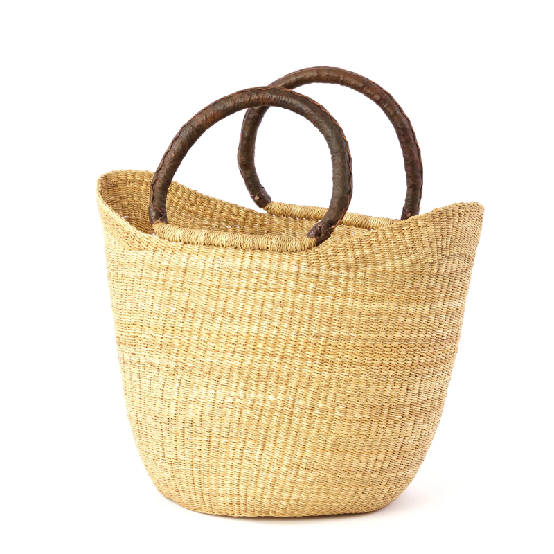 This image showcases a beautifully handwoven shopper bag made from natural fibers, featuring sturdy leather handles for durability and style. The natural tone adds elegance, making it perfect for daily errands or as a chic accessory for the farmer's market.