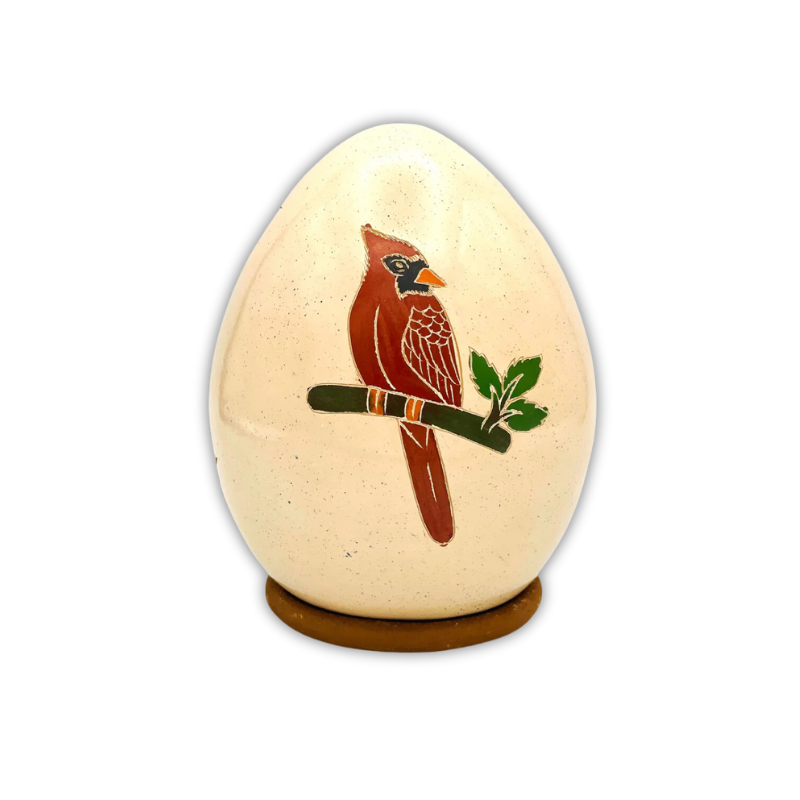 Handcrafted ceramic luminary featuring a beautifully painted cardinal perched on a branch with leaves, showcasing intricate artisan craftsmanship and a natural theme.