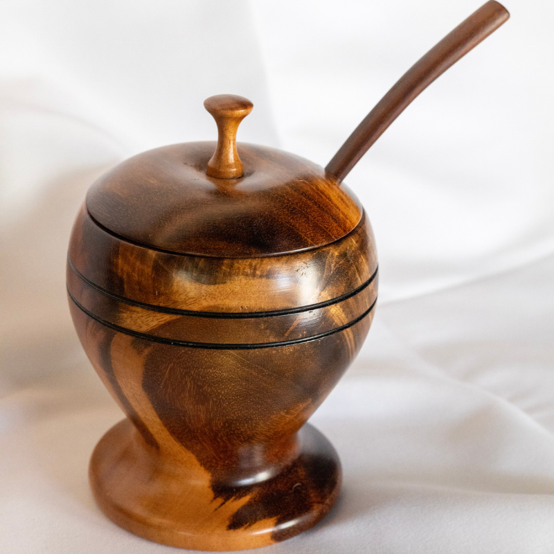 Handcrafted wooden sugar bowl with a smooth finish, paired with a matching lid and spoon. Ideal for storing sugar, honey, or condiments, combining functionality with rustic elegance.
