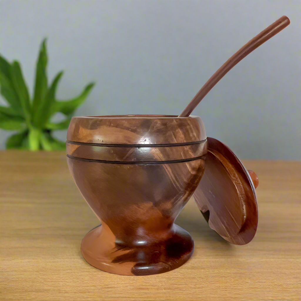 Handcrafted wooden sugar bowl with a smooth finish, paired with a matching lid and spoon. Ideal for storing sugar, honey, or condiments, combining functionality with rustic elegance."